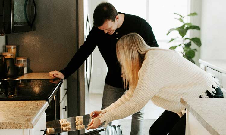 cooking yourself at home, couple at the oven