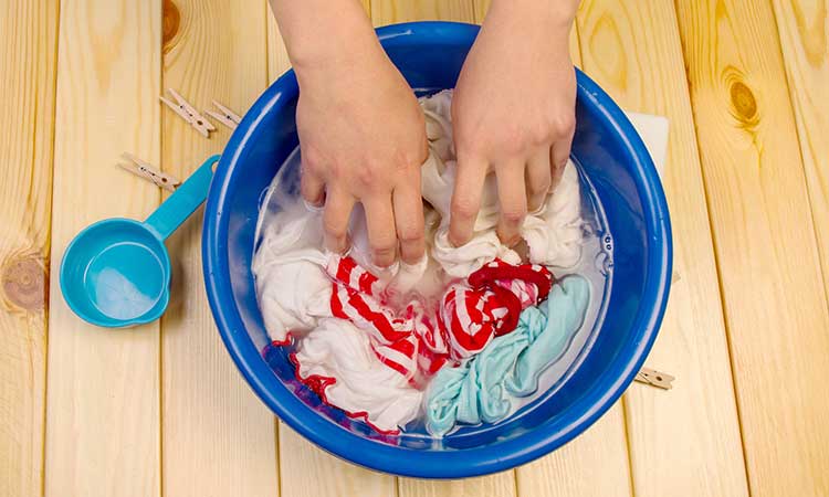 Soak laundry, blue bowl with hands and laundry