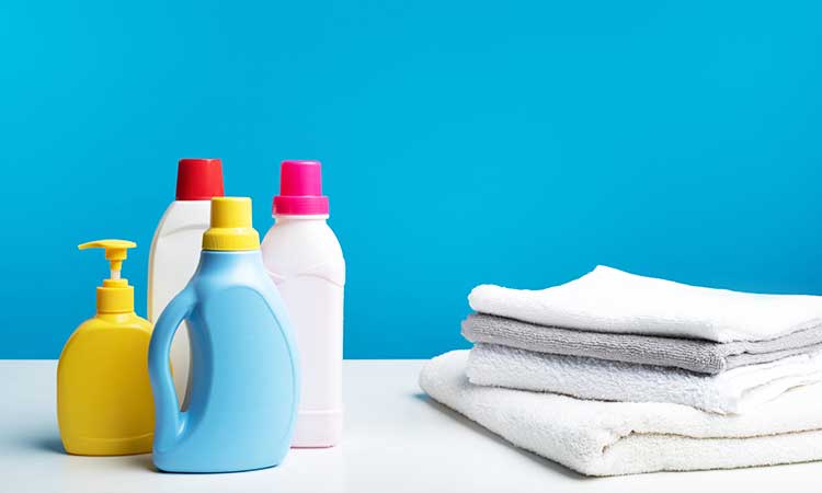 white linen, four bottles of detergent next to white towels